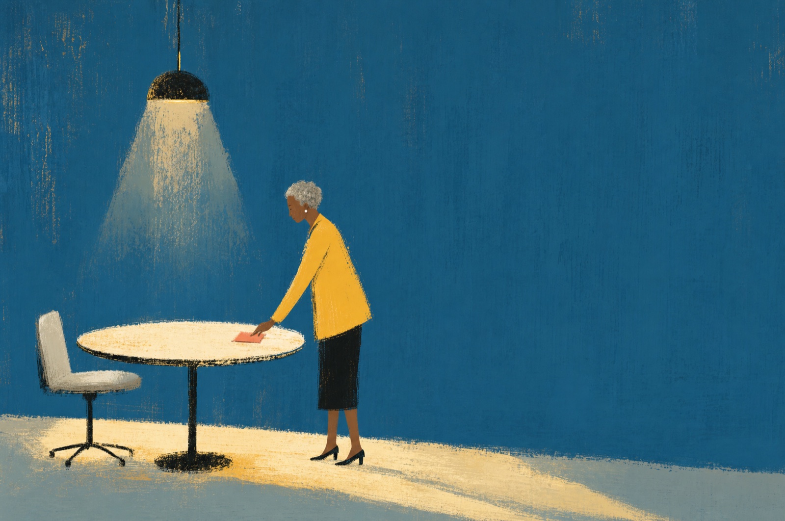 A woman under a hanging lamp laying out pages on a round table, on a deep blue wall
